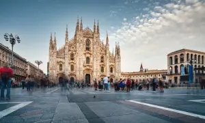 Piazza del Duomo a Milano, con la cattedrale imponente e gente che passeggia. Un luogo dove si respira la storia e i proverbi milanesi.