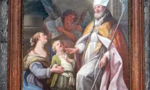 San Biagio, con mitra e pastorale, benedice un bambino. Il nome Biagio evoca protezione e guarigione.