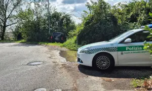 Sei di Paderno Dugnano se vedi la Polizia locale vicino a un'auto nera parcheggiata male e una pozzanghera sull'asfalto.