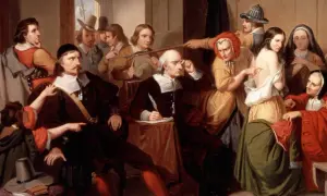 Un gruppo di persone esamina una giovane donna, cercando segni fisici delle streghe. Un uomo scrive, mentre altri osservano con sospetto.
