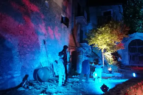 Scenografia suggestiva per la festa delle streghe in Abruzzo. Figure misteriose e luci colorate creano un'atmosfera magica.
