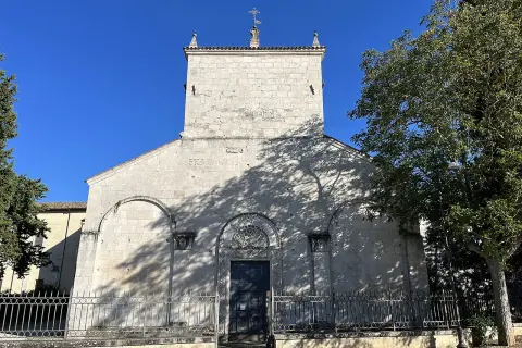 Chiesa di San Pelino a Corfinio, un'antica struttura in pietra sotto un cielo azzurro.