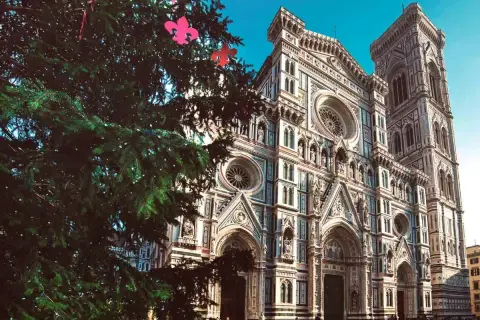 Un albero di Natale addobbato con fiocchi rosa davanti al Duomo di Firenze, un luogo dove si festeggia la Befana in Italia.