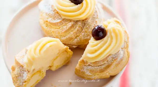 Zeppole di San Giuseppe, dolci soffici con crema pasticcera e ciliegina, perfette per la festa del papà. La ricetta delle zeppole di San Giuseppe è un classico.