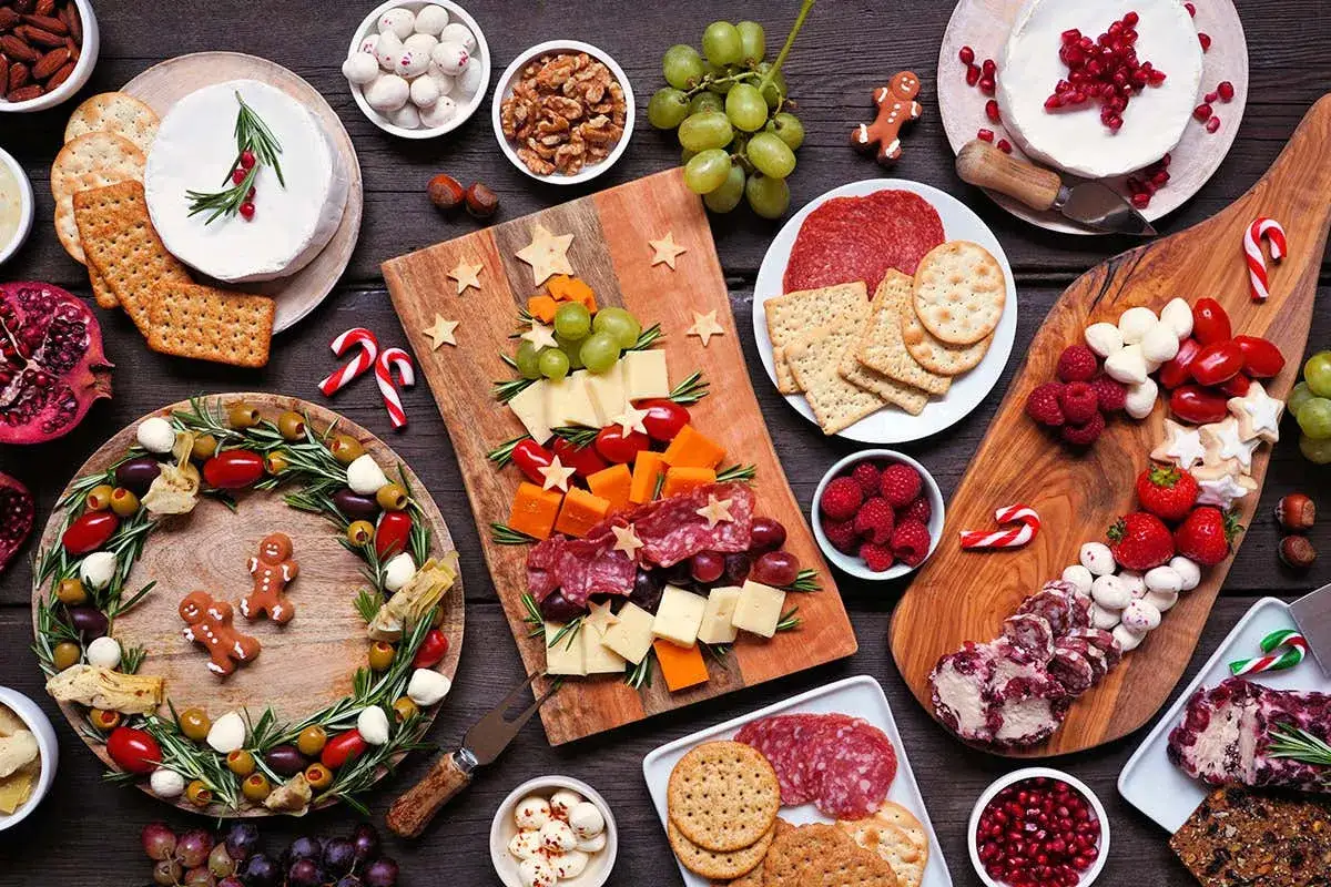 Un ricco buffet con formaggi, salumi, frutta e biscotti a tema natalizio, perfetto per celebrare le tradizioni di Capodanno.