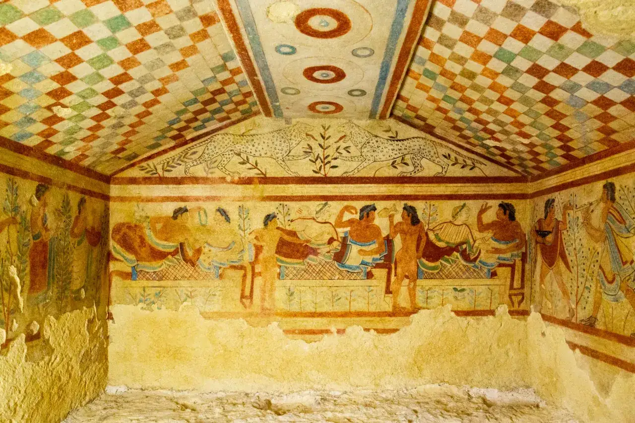 Affresco in una tomba etrusca, che illustra scene di banchetto e animali, rivelando il necropoli significato come luogo di vita dopo la morte.