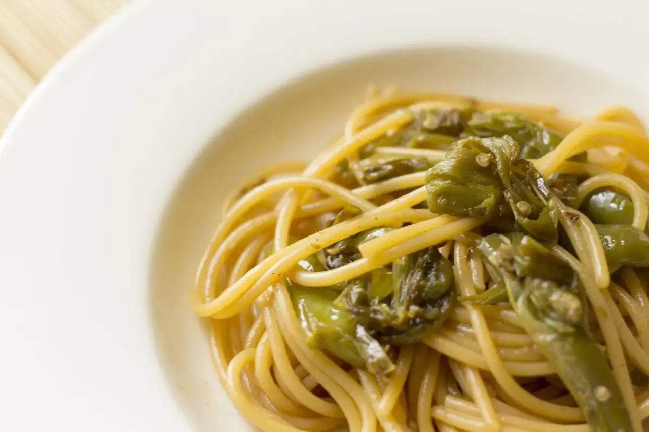 Spaghetti con crema di friarielli, un piatto semplice e gustoso, con i friarielli che avvolgono la pasta in un abbraccio saporito.
